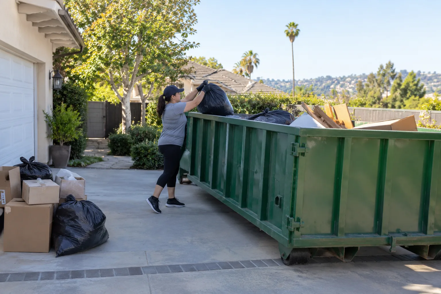 Cleanup debris being loaded into a dumpster